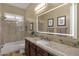 Bathroom featuring an illuminated mirror, granite counters, and tiled shower-tub combo at 14708 E Canyoncrest Ct, Fountain Hills, AZ 85268