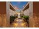 Inviting courtyard entrance with desert landscaping, lighting, and a view of the front gate at 14708 E Canyoncrest Ct, Fountain Hills, AZ 85268