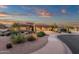 Beautiful home exterior with lush desert landscaping, sidewalk and a convenient two car garage at 14708 E Canyoncrest Ct, Fountain Hills, AZ 85268