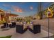 Inviting backyard featuring a stone fire pit with comfortable seating under a colorful evening sky at 14708 E Canyoncrest Ct, Fountain Hills, AZ 85268