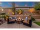 Relaxing backyard with a cozy stone fire pit and comfortable seating, perfect for evening gatherings at 14708 E Canyoncrest Ct, Fountain Hills, AZ 85268