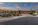 Beautiful single story home at dusk with desert landscaping, warm lighting, and an inviting driveway at 14708 E Canyoncrest Ct, Fountain Hills, AZ 85268