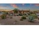 Expansive front yard featuring desert landscaping with mature plants, trees, and a two-car garage at 14708 E Canyoncrest Ct, Fountain Hills, AZ 85268