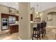 Open-concept kitchen with stainless steel appliances, a breakfast bar, and custom cabinetry at 14708 E Canyoncrest Ct, Fountain Hills, AZ 85268