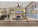Inviting living room features a fireplace, TV, ceiling fan, and comfortable seating for relaxation at 14708 E Canyoncrest Ct, Fountain Hills, AZ 85268
