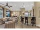 Open concept living room, bar with seating, and dining area perfect for entertaining guests at 14708 E Canyoncrest Ct, Fountain Hills, AZ 85268