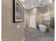 Luxurious main bathroom featuring tile flooring, tub inside a glass shower, and an accent wall at 14708 E Canyoncrest Ct, Fountain Hills, AZ 85268