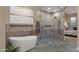 A luxurious main bath offers a large shower, freestanding tub, tile flooring, and a decorative accent wall at 14708 E Canyoncrest Ct, Fountain Hills, AZ 85268