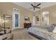 Open main bedroom featuring ceiling fan, carpet flooring, TV, access to the patio and entry to the main bath at 14708 E Canyoncrest Ct, Fountain Hills, AZ 85268