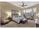 Bright main bedroom with neutral walls, carpet flooring, ceiling fan, shuttered windows, and stylish furnishings at 14708 E Canyoncrest Ct, Fountain Hills, AZ 85268