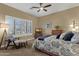 Relaxing main bedroom with neutral tones, ceiling fan, and a large shuttered window provides ample natural light at 14708 E Canyoncrest Ct, Fountain Hills, AZ 85268