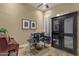 Office space featuring a modern desk setup, a piano, and ample storage with a glass-front cabinet at 14708 E Canyoncrest Ct, Fountain Hills, AZ 85268