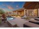 Resort-style backyard oasis with a sparkling pool, lounge areas, and desert landscaping at 14708 E Canyoncrest Ct, Fountain Hills, AZ 85268
