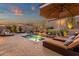 Beautiful backyard swimming pool with spa, desert plants, lounge chairs, and shaded seating area at 14708 E Canyoncrest Ct, Fountain Hills, AZ 85268