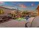 Inviting backyard pool area with small waterfall feature, desert plants, and comfortable lounge seating at 14708 E Canyoncrest Ct, Fountain Hills, AZ 85268