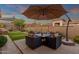Well-manicured backyard putting green with nearby outdoor seating and umbrella at 14708 E Canyoncrest Ct, Fountain Hills, AZ 85268