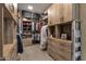 Large walk-in closet with built-in shelves, drawers and hanging rods for organized clothing and accessories at 14708 E Canyoncrest Ct, Fountain Hills, AZ 85268