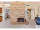 Stone fireplace in living room with views into other rooms, showcasing an open floor plan at 15827 S 12Th Pl, Phoenix, AZ 85048