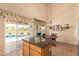 Eat-in kitchen includes a center island, breakfast nook, and sliding door access to the outdoor pool area at 15827 S 12Th Pl, Phoenix, AZ 85048