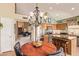 Eat-in kitchen with granite counters, stainless steel appliances, wooden cabinets, open to the living room and dining area at 15827 S 12Th Pl, Phoenix, AZ 85048