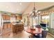 Eat-in kitchen with granite counters, wooden cabinets, stainless steel appliances, and convenient island with barstool seating at 15827 S 12Th Pl, Phoenix, AZ 85048