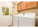Functional laundry room with a washer, dryer, and ample cabinet space for storage at 15827 S 12Th Pl, Phoenix, AZ 85048
