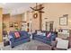 Comfortable living room featuring a stone fireplace, vaulted ceilings, and views into the adjacent dining area at 15827 S 12Th Pl, Phoenix, AZ 85048