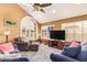 Bright living room with large windows, vaulted ceiling, ceiling fan, and comfortable seating area at 15827 S 12Th Pl, Phoenix, AZ 85048