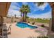 Sparkling pool with views of the golf course, surrounded by lush landscaping and towering palm trees at 15827 S 12Th Pl, Phoenix, AZ 85048