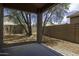 Covered patio overlooking the backyard, surrounded by mature landscaping and block fencing at 1742 E Chaparral Dr, Casa Grande, AZ 85122