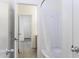 Bright bathroom showcasing a shower-tub combo with white shower curtain and white tile flooring at 1742 E Chaparral Dr, Casa Grande, AZ 85122
