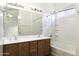 Bathroom with a combination shower and tub and a wood vanity with a bright vanity mirror at 1742 E Chaparral Dr, Casa Grande, AZ 85122