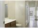 Bathroom with vanity, sink, toilet, and tiled floors leading to a bright shower-tub combo at 1742 E Chaparral Dr, Casa Grande, AZ 85122