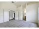 Primary bedroom featuring a carpeted floor and access to an ensuite bathroom and a closet at 1742 E Chaparral Dr, Casa Grande, AZ 85122