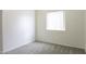 Bedroom featuring neutral carpet, a large window with blinds, and white walls at 1742 E Chaparral Dr, Casa Grande, AZ 85122