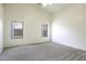 Well-lit carpeted bedroom featuring a ceiling fan and views to the exterior backyard block wall at 1742 E Chaparral Dr, Casa Grande, AZ 85122