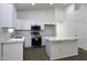 Modern kitchen featuring white cabinetry, stainless steel appliances, and marble countertops at 1742 E Chaparral Dr, Casa Grande, AZ 85122