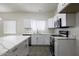 Bright kitchen featuring white cabinets, stainless steel appliances, and an island with quartz countertops at 1742 E Chaparral Dr, Casa Grande, AZ 85122