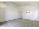Bright, carpeted living room with an elegant hanging light fixture, vaulted ceilings and an arched doorway at 1742 E Chaparral Dr, Casa Grande, AZ 85122
