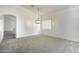 Bright, carpeted living room with an elegant hanging light fixture and vaulted ceilings at 1742 E Chaparral Dr, Casa Grande, AZ 85122