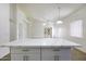 Open-concept living room and kitchen area, showcasing quartz countertops and access to the backyard at 1742 E Chaparral Dr, Casa Grande, AZ 85122