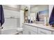 Bright bathroom with quartz counters, white cabinets, a shower-tub combo, and modern finishes at 17479 W Victory St, Goodyear, AZ 85338