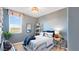 Blue bedroom featuring a cozy bed, baseball decor, and lots of natural light at 17479 W Victory St, Goodyear, AZ 85338