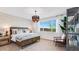 Comfortable bedroom featuring a decorative light fixture, wallpaper, and an accent chair at 17479 W Victory St, Goodyear, AZ 85338