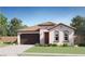 Charming single-story home with a terracotta tile roof, well-manicured lawn, and a two-car garage at 17479 W Victory St, Goodyear, AZ 85338