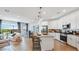 Open-concept kitchen featuring modern appliances, a center island with seating, and seamless flow into the living area at 17479 W Victory St, Goodyear, AZ 85338