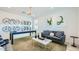Bright, modern living room featuring a pool table, stylish decor, and comfortable seating for entertaining at 17479 W Victory St, Goodyear, AZ 85338