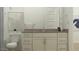 Bright bathroom featuring a white vanity with modern hardware and stylish decor at 17539 W Victory St, Goodyear, AZ 85338