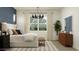 Well-lit bedroom with a comfortable bed, decorative pillows, and elegant furnishings at 17539 W Victory St, Goodyear, AZ 85338