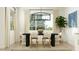 Bright dining room featuring a modern chandelier, large window, and stylish decor at 17539 W Victory St, Goodyear, AZ 85338